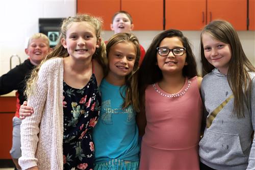 Gates Elementary students standing in a classroom smiling